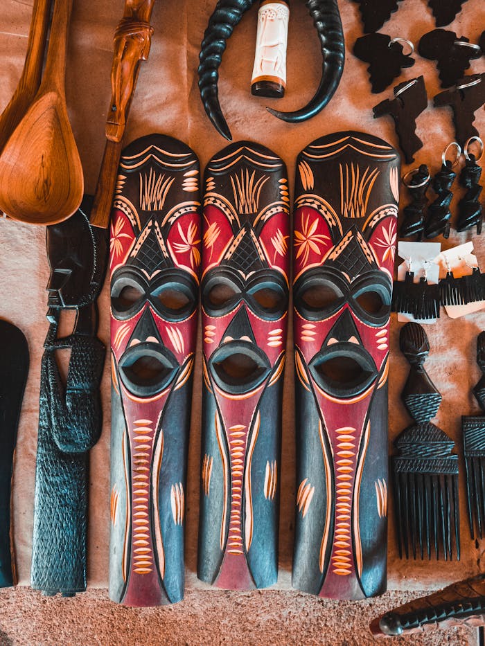 Vibrant tribal masks with intricate designs displayed alongside traditional decor items. Perfect for cultural themes.